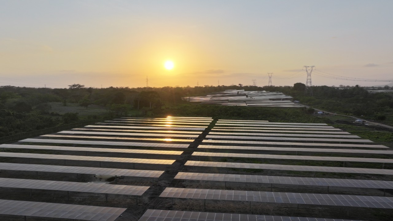Vista aérea de un parque solar con extensos paneles fotovoltaicos en un entorno natural